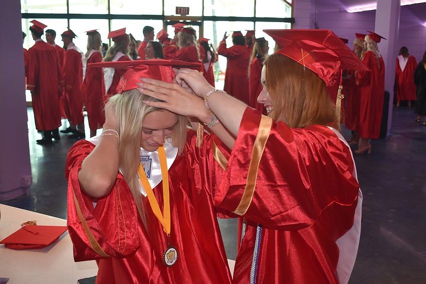 Tayler Snelling has her cap adjusted by Elle Vanderpol.