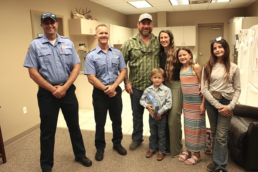 Firefighters James Bacigalupi and Trevor Garofalo join Cody, Harry, Allee, Avaree, and Audree Noordzy during a five-year reunion of Harry's birth at Station 12 in Myakka.
