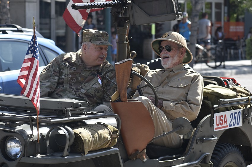 Dwight Thompson and Dale Aylward of Florida Military Vehicle Heritage Group chat as the parade gets underway.