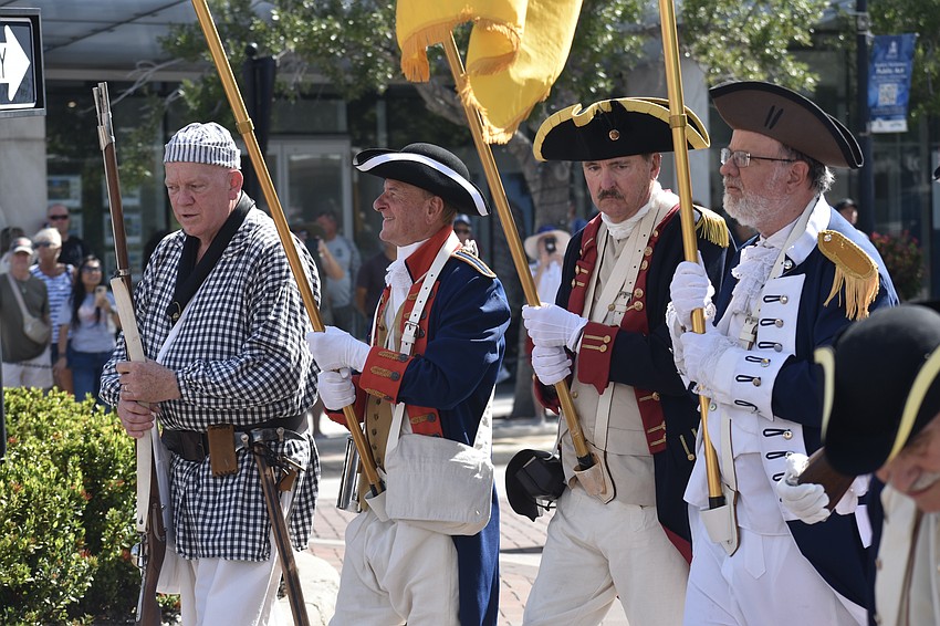 Members of Sons of the American Revolution lead the parade.