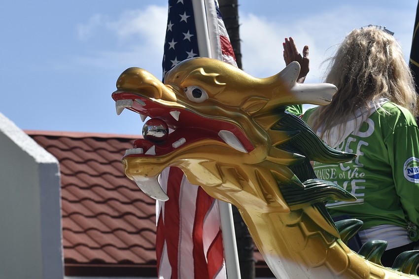 A float representing dragon boat paddling at Nathan Benderson Park passes along the route.