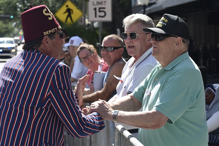 David Walters of Sahib Shriners greets Hank Maier and Jack Slusser.