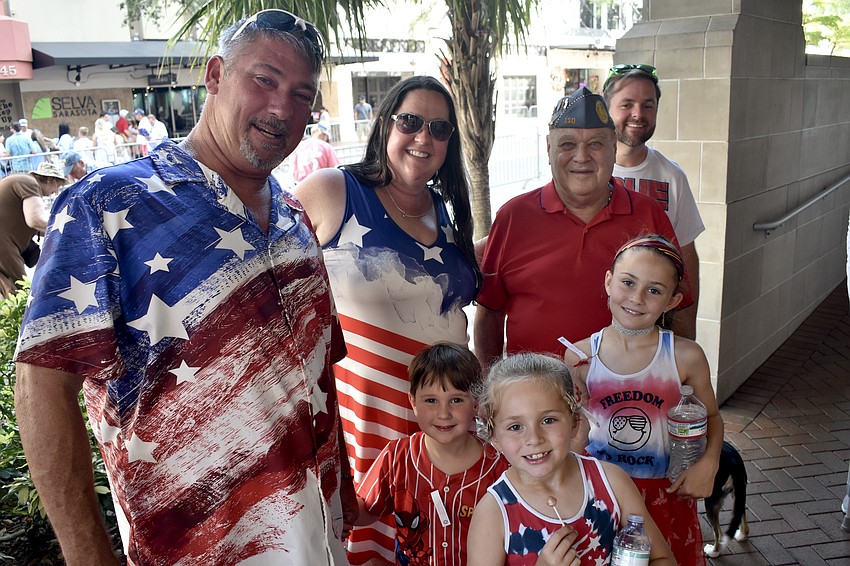 Jeffrey and Candice Hill, Silas Hill, 4, Faith Curtis, 7, Harry Steever of Sons of The American Legion, Erith Curtis, 9 and John Curtis enjoyed watching the parade.