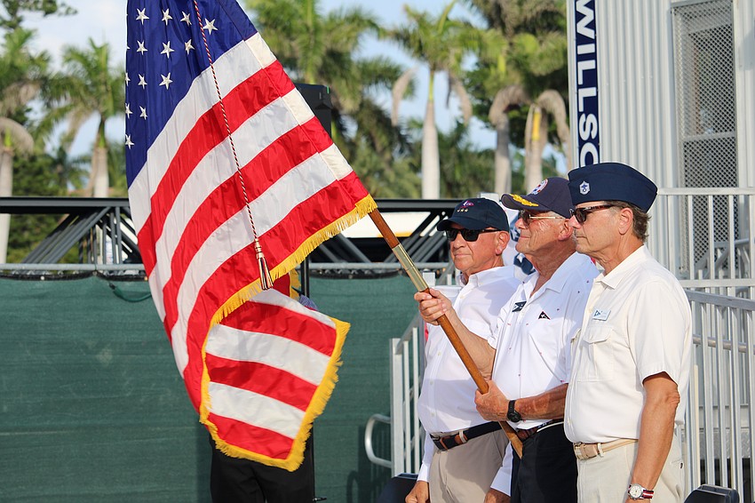Color guard members Michael Landis, Jay Plager and Mark Akerman raise the flag.