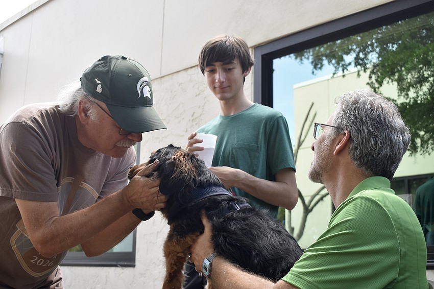 Robert Zack and his grandson Ben Fairweather, 16, bring Willy for a blessing from Rabbi Brenner Glickman.
