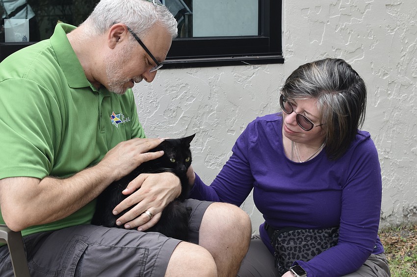 Rabbi Michael Shefrin meets Susan Eriksen and her cat Nellie.