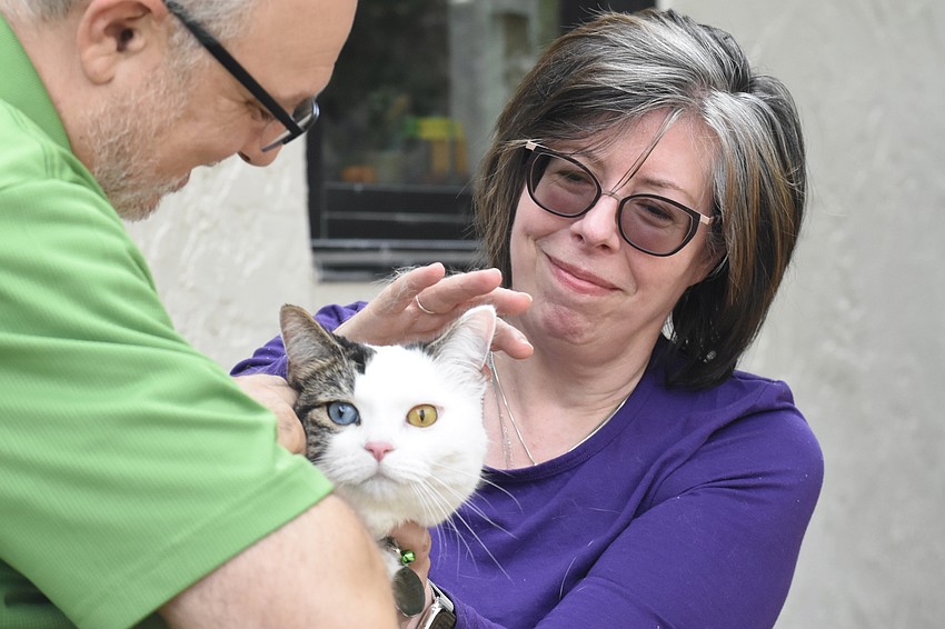 Rabbi Michael Shefrin blesses Susan Eriksen's cat Bobby Jones.