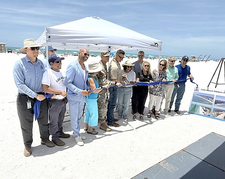 Sarasota Mayor Debbie Trice and Congressman Greg Steube are front and center for the ribbon cutting to mark the completion of Lido Beach renourishment.