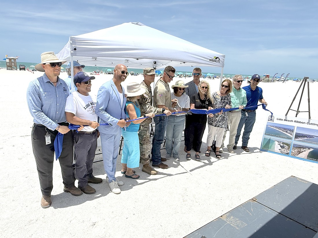 Sarasota Mayor Debbie Trice and Congressman Greg Steube are front and center for the ribbon cutting to mark the completion of Lido Beach renourishment.