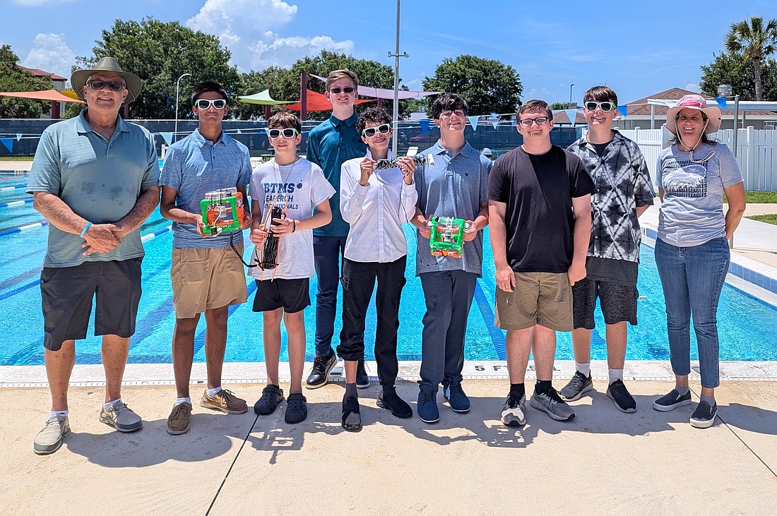 Buddy Taylor Middle School SeaPerch competitors practiced for the last time at the Palm Coast Aquatics Center on May 26 before flying to Maryland for the international competition, May 30-31. Coach Tracy Jones is at right; assistant coach Michael Bozzo is at left. Photo by Brent Woronoff