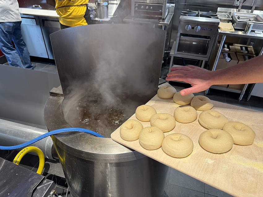 The bagels boil for about 45 seconds in water before settling and baking.