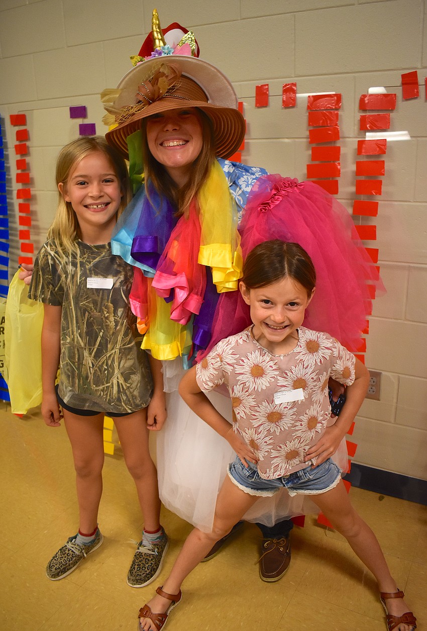 Representing second grade are Chloe Erickson, teacher Kera Picker and Sage Dodge who take a moment to appreciate their outfit before revealing it to the crowd.
