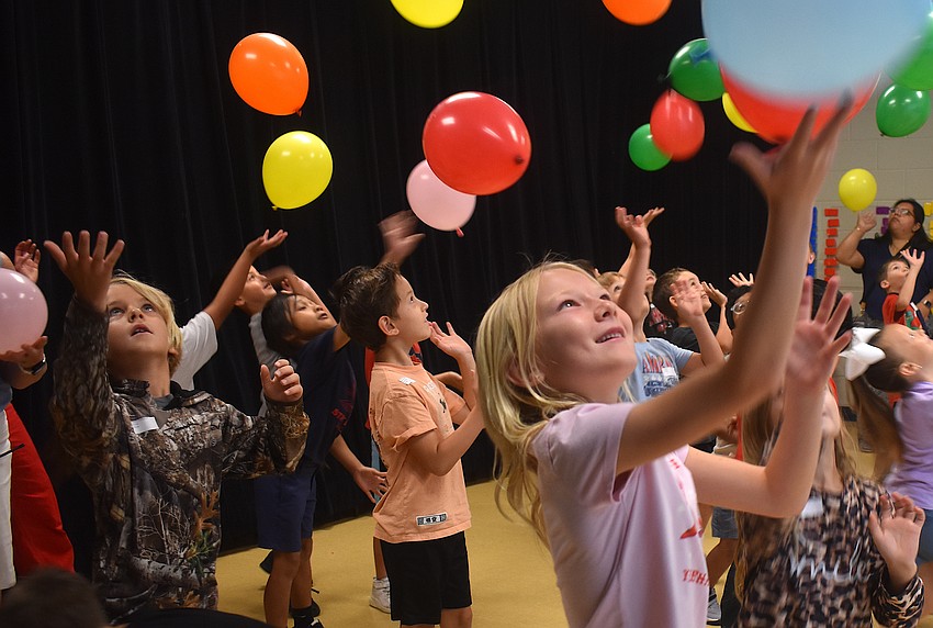 Maclin Seguin and Bristol Zadai, first graders at Myakka City Elementary, try to keep the balloons in the air for the Balloon Bump Dance Party.