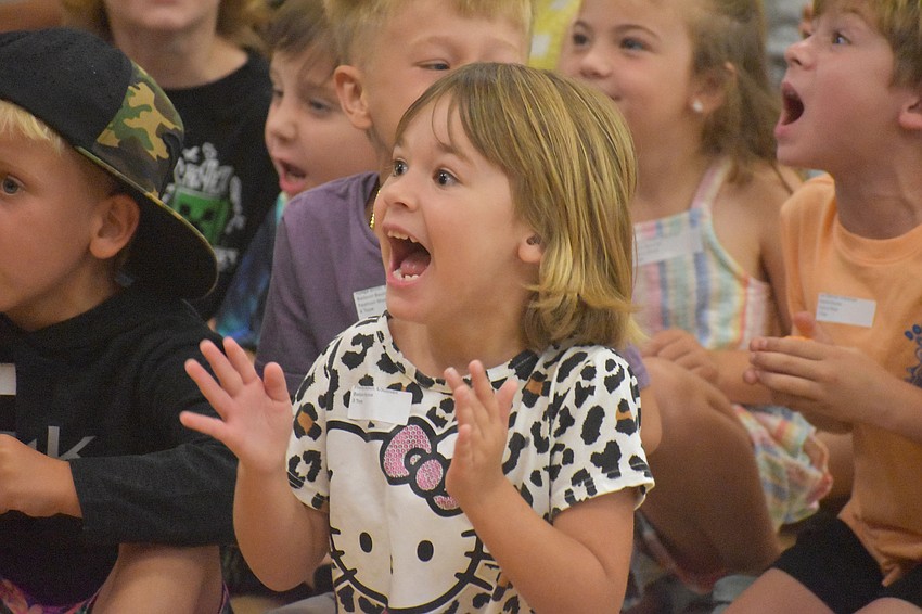 Presley Baldwin, kindergartener at Myakka City Elementary, seems to be the #1 fan of the Tacky Fashion Show during the Jump a Bucket event.