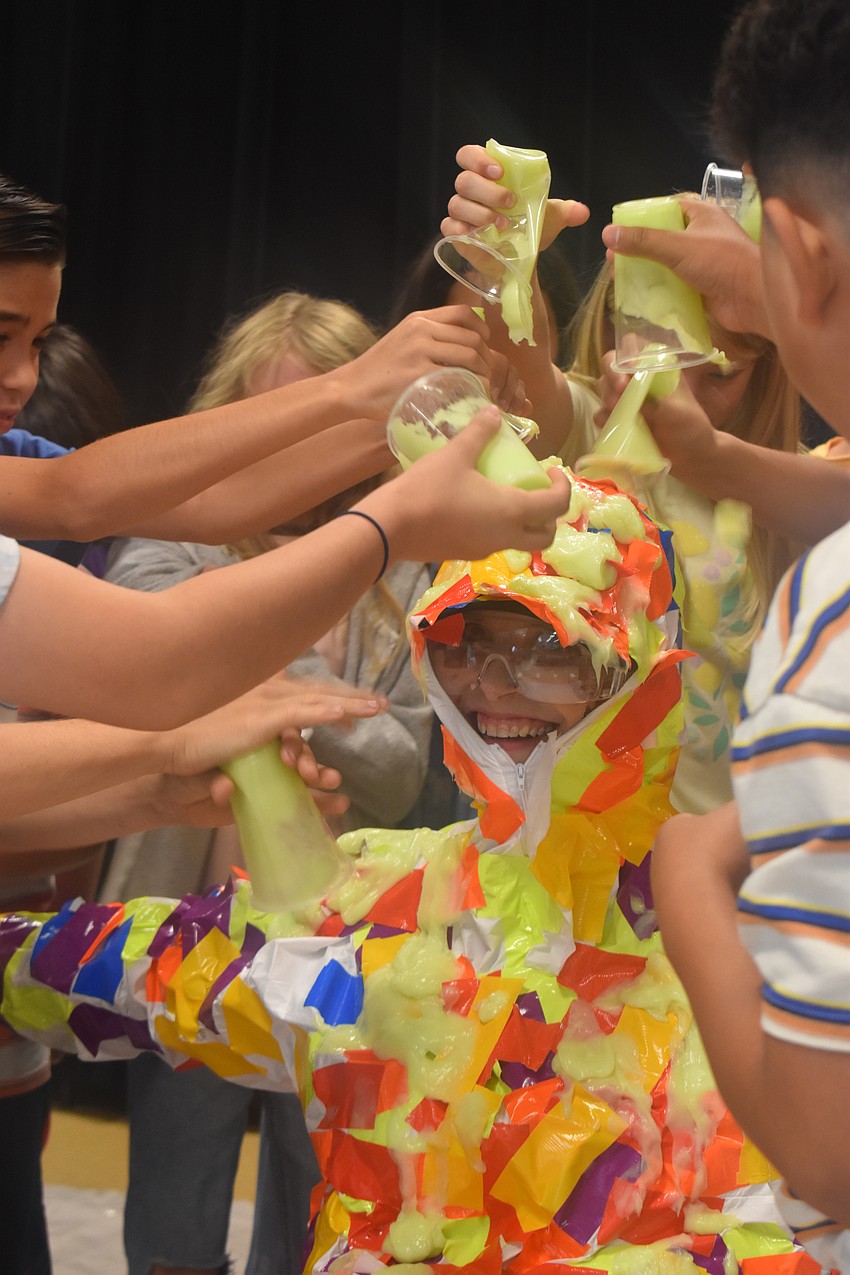 The fifth grade students, who earned a level three or above on the Florida Assessment of Student Thinking for science, are able to slime Principal Carol Ricks.