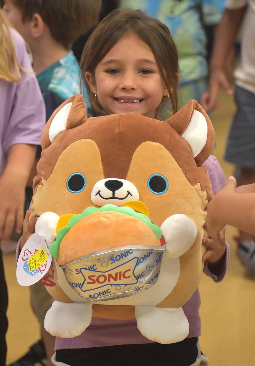 Kinley Lucas, a kindergarten student at Myakka City Elementary, chose a Sonic Squishmallow as her prize at the Jump a Bucket event.