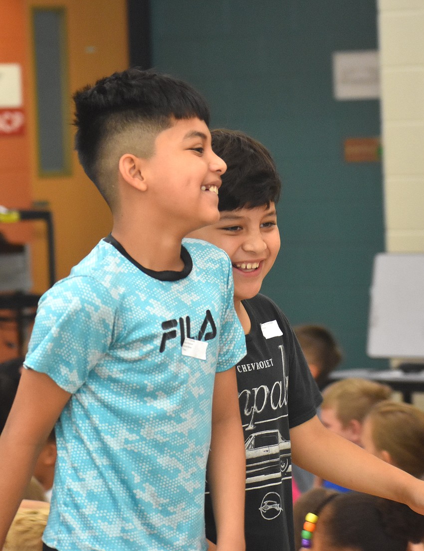 Joel Diaz-Alverado and Michael Garcia-Mijangos, fourth graders at Myakka City Elementary, follow the line during the fashion show.