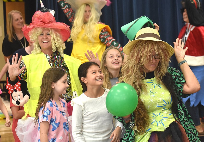 Paraprofessional Veronica Young, third graders Samantha Coleman, Sherlyn Ambrosio-Vargas, Dakota Bryant and Third Grade Teacher Morgan Smith make their way down the runway during the Tacky Fashion Show.