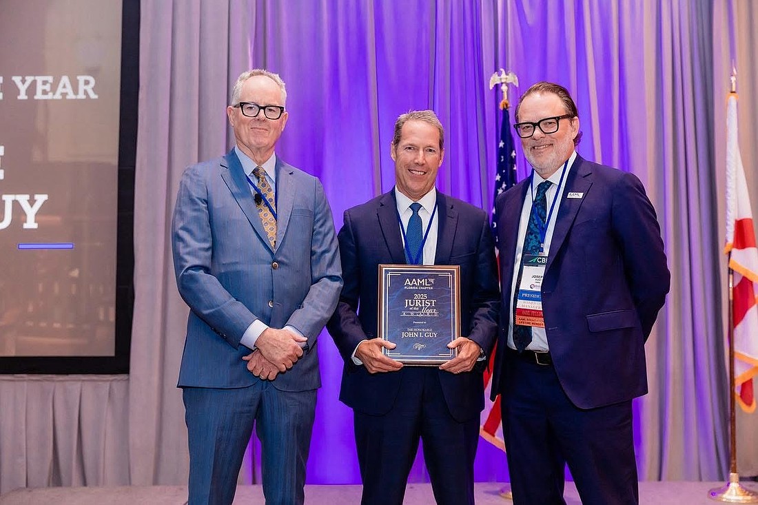 From left, attorney Mark Sessums; 4th Circuit Judge John Guy, recipient of the Jurist of the Year Award from the Florida Chapter of the American Academy of Matrimonial Lawyers; and chapter President Joseph Hunt.