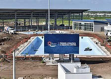 The pools are waiting on water, and the shaded pickleball structure behind them is waiting on paint for the courts.