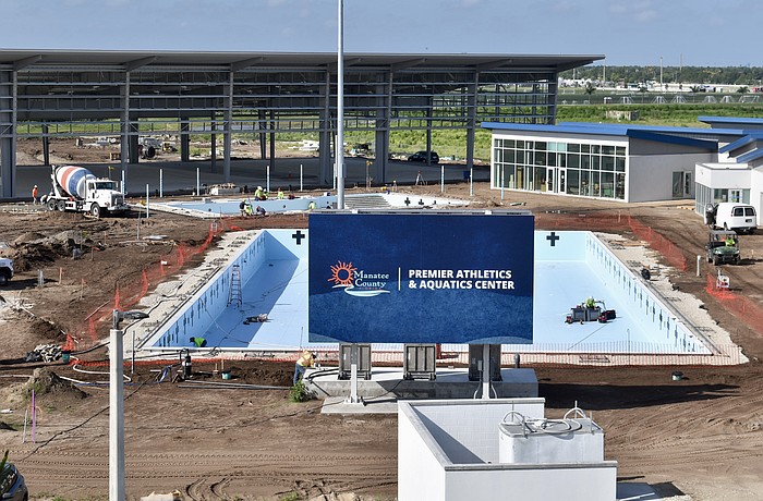 The pools are waiting on water, and the shaded pickleball structure behind them is waiting on paint for the courts.