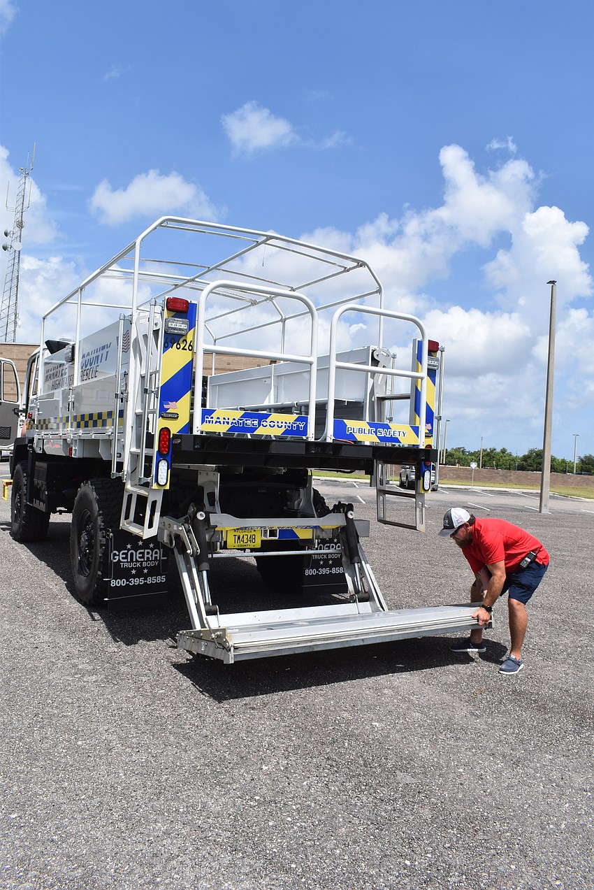 Captain Marshall Greene folds the lift gate back in place. The lift makes the vehicle accessible to all residents.