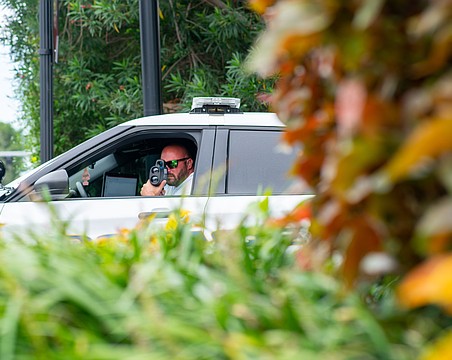 A Longboat Key police officer measures the speed of vehicles traveling on Gulf of Mexico Drive. Traffic enforcement in gated communities require a memorandum of understanding with the Homeowners Association, said Longboat Key Police Chief Russ Mager.