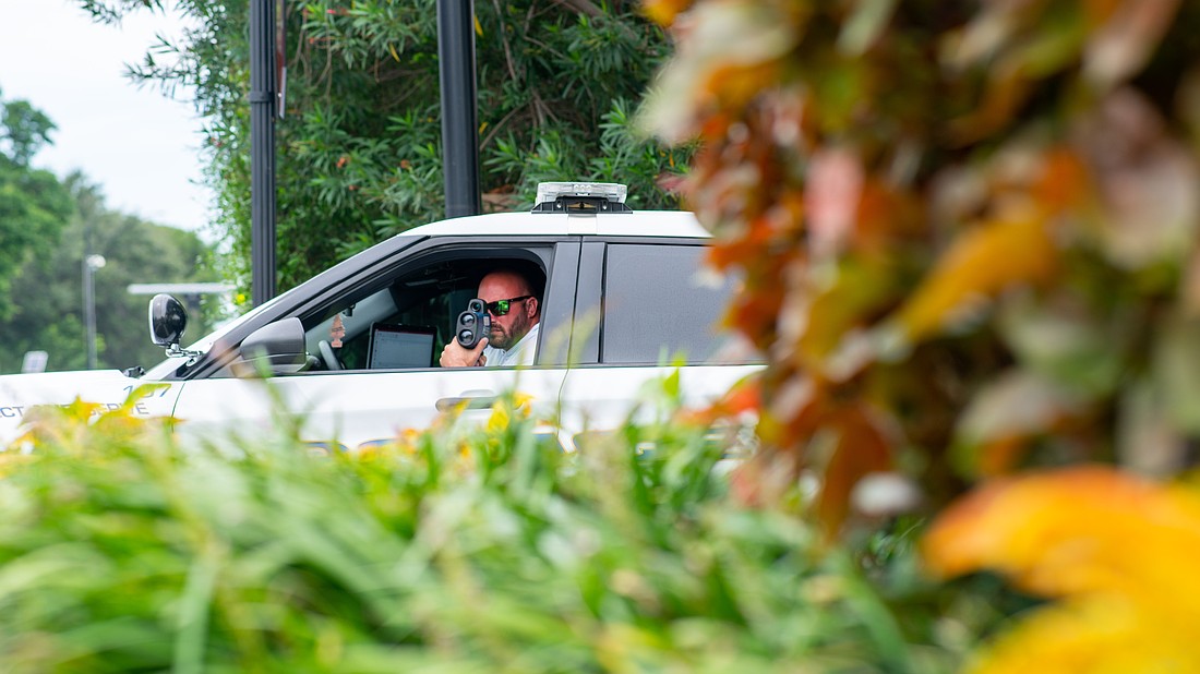 A Longboat Key police officer measures the speed of vehicles traveling on Gulf of Mexico Drive. Traffic enforcement in gated communities require a memorandum of understanding with the Homeowners Association, said Longboat Key Police Chief Russ Mager.