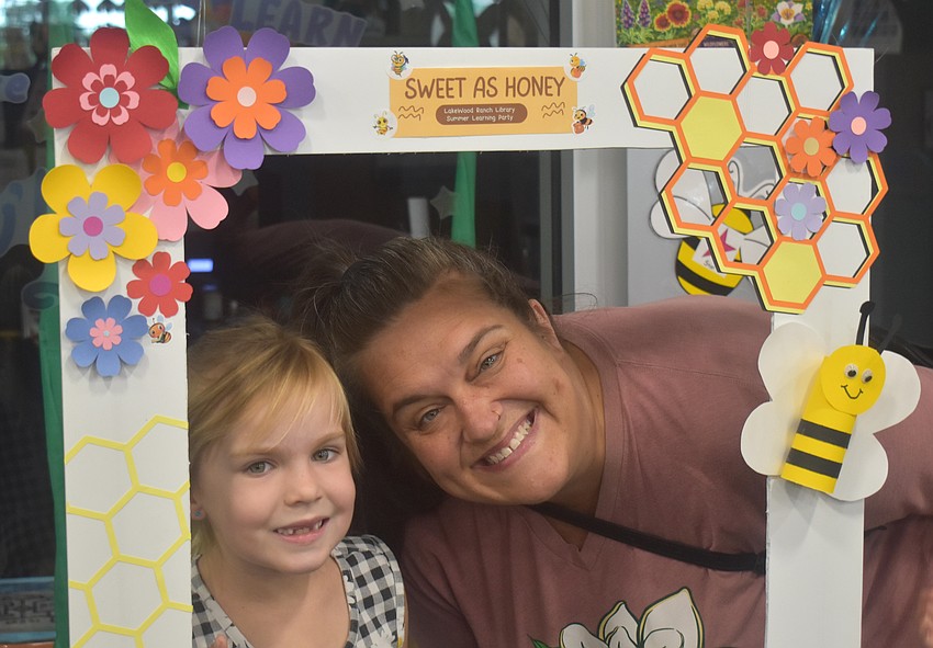 Bradenton's Maggie Reece, 6, and her mom, Jenna Reece, strike a pose at the bee themed Summer Learning Kickoff Party at Lakewood Ranch Library.