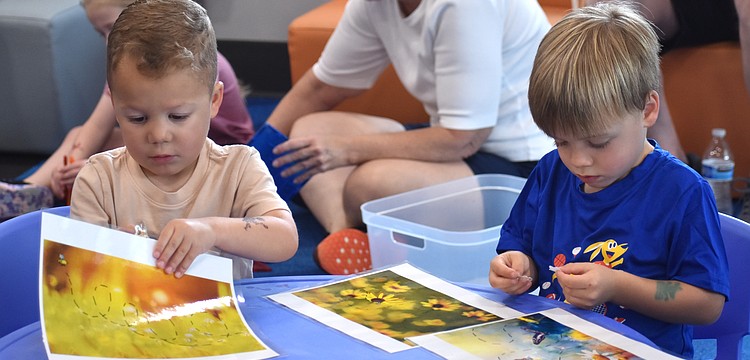Lakewood Ranch's Cole Mule and Bodie Hogan, both 3 years old, explore the bee-themed magnet activity.