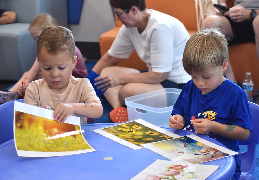 Lakewood Ranch's Cole Mule and Bodie Hogan, both 3 years old, explore the bee-themed magnet activity.