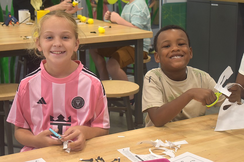 Lakewood Ranch's Tessa Martin, 8, and Antonio, Texas's Jordan Glover, 6, are all smiles at the arts and crafts station at the Lakewood Ranch Library.