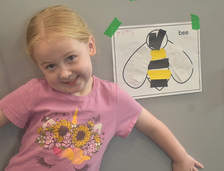 Parrish's Ava Sharpe, 5, is glad to show off her artwork at the Summer Learning Program Kickoff Party at the Lakewood Ranch Library.