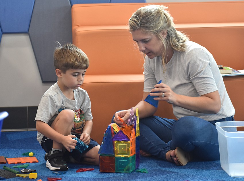 Lakewood Ranch's Jena Lieb and her son, 4-year-old Brooks Lieb, use their creativity to build with magnetic tiles at the Summer Learning Program Kickoff Party.