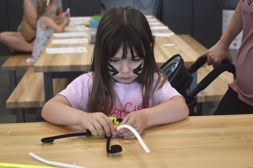 Bradenton's Cece Kinney, 5, enjoys designing her headband with flowers and likes crafts because they make her feel relaxed.