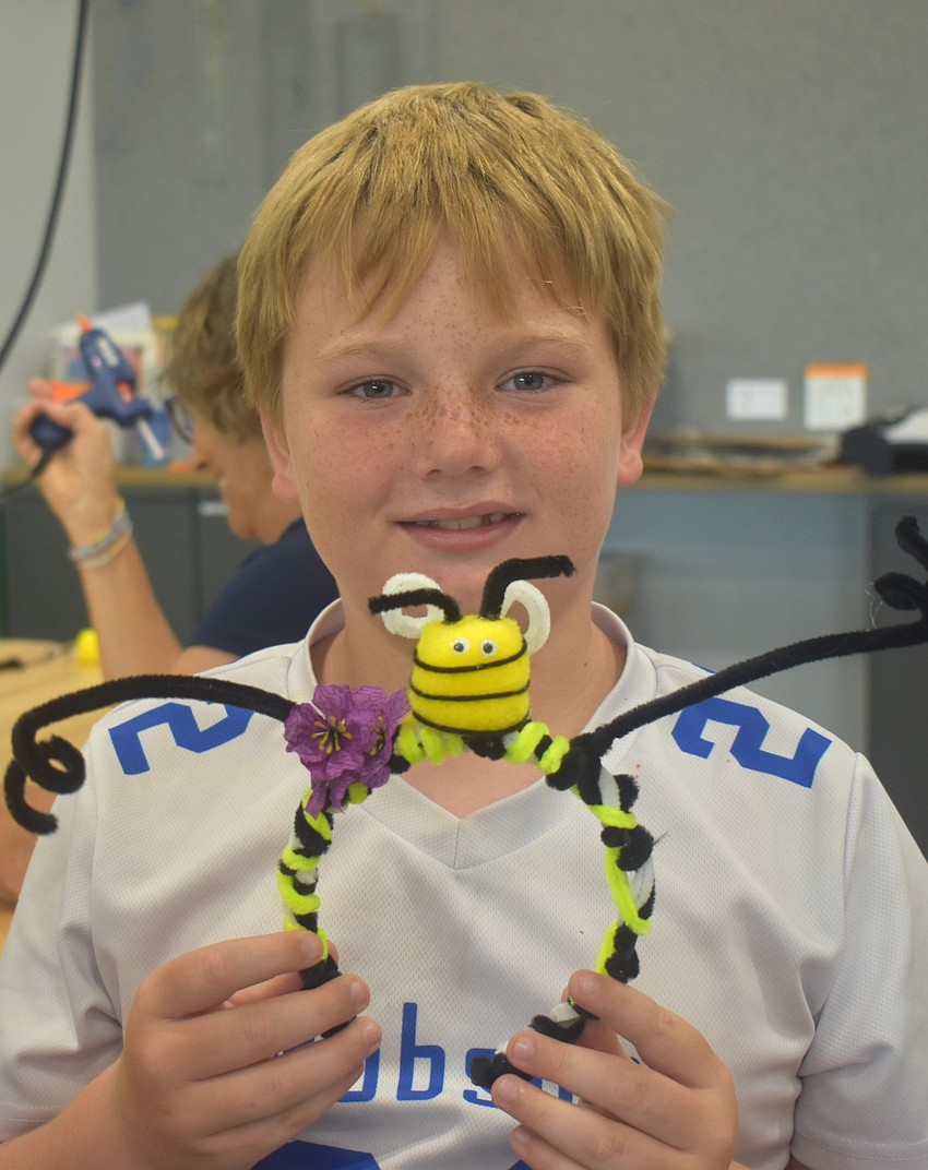 Lakewood Ranch's Reed Robson adds a bee on top of his headband at the Summer Learning Program Kickoff Party.