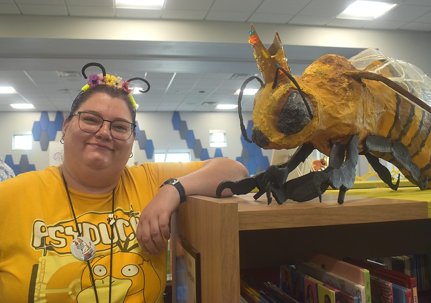 Hayley Rigatti, the workshops coordinator at the Lakewood Ranch Library, is one of the people behind the bee-themed decorations, including this paper mache bee.