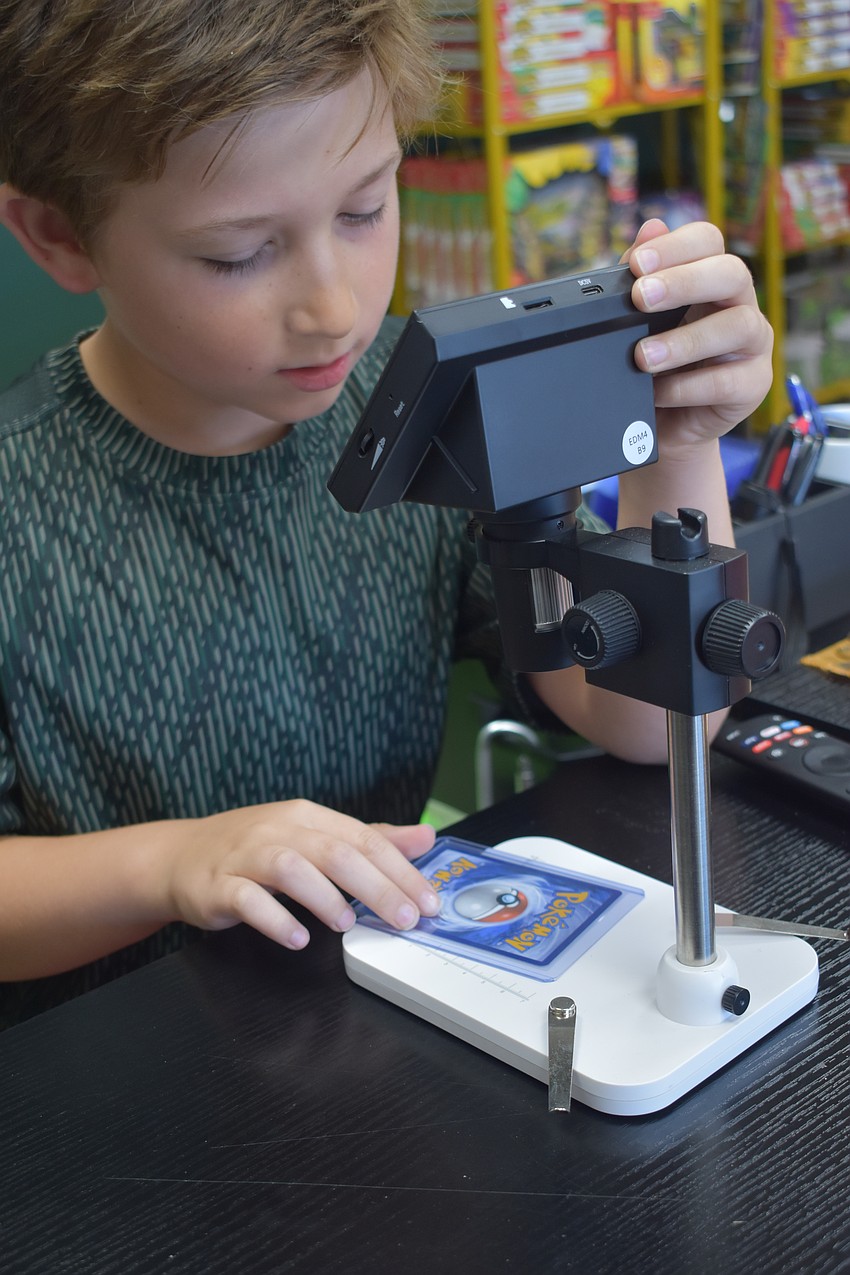 Silas Stacy pre-grades a card.