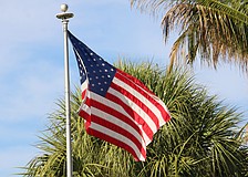 An American flag flies on Gulf of Mexico Drive, the town’s main thoroughfare that will soon see much more red, white and blue as the town prepares to install 56 light pole banners.