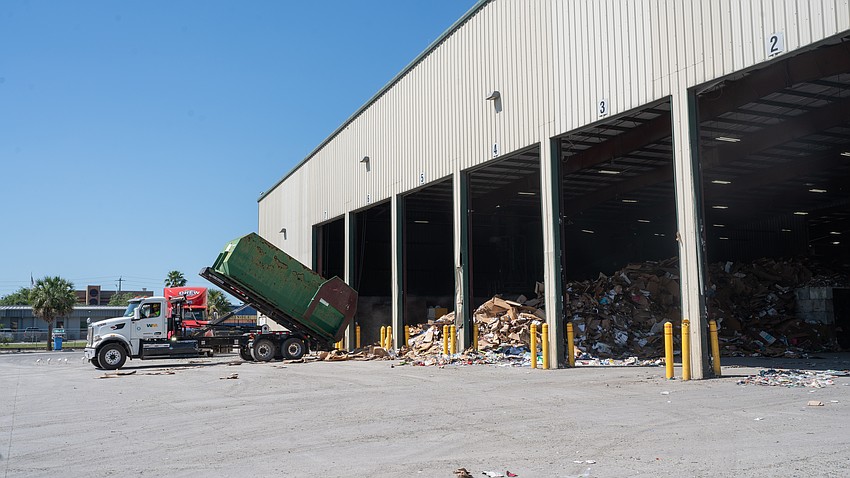 A truckload of recyclables dumps a load onto the tipping room floor of Circular Services’ materials recovery facility in Sarasota. Both Manatee and Sarasota counties contract with Circular Services to process their curbside recyclables.