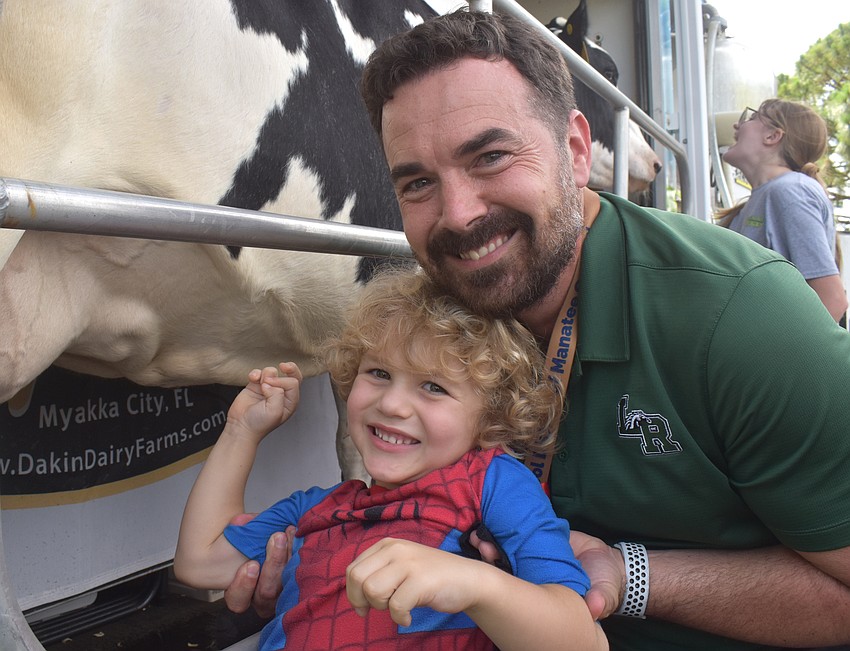 Bradenton's Bastian Bellantonio, 4, and his dad, Assistant Principal Thomas Bellantonio, couldn't resist stopping by the Junior Rancher's Agriculture Summer Camp to milk the cow.