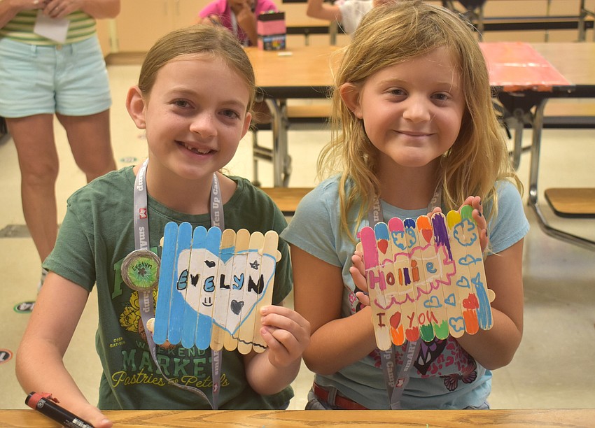 Evelyn Colley and Hollie Miesner, both rising third graders at Palma Sola Elementary, are happy to show off their art projects which are to resemble fences with graffiti art.