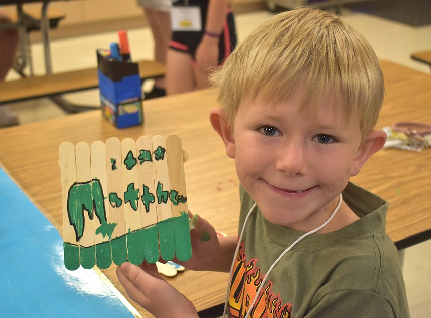 Matthew Servetz, a rising third grader at Tara Elementary School, matches his art project with his shirt using the color green.