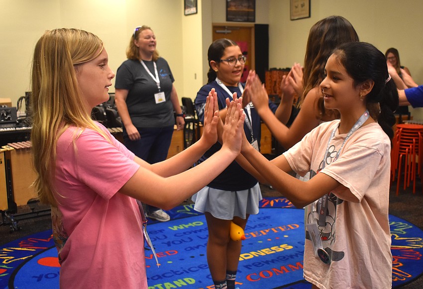 Skylar Flandreau, a rising sixth grader at Martha B. King Middle School, and Arianna Medina, a rising fifth grader at Braden River Elementary School, sing the song 