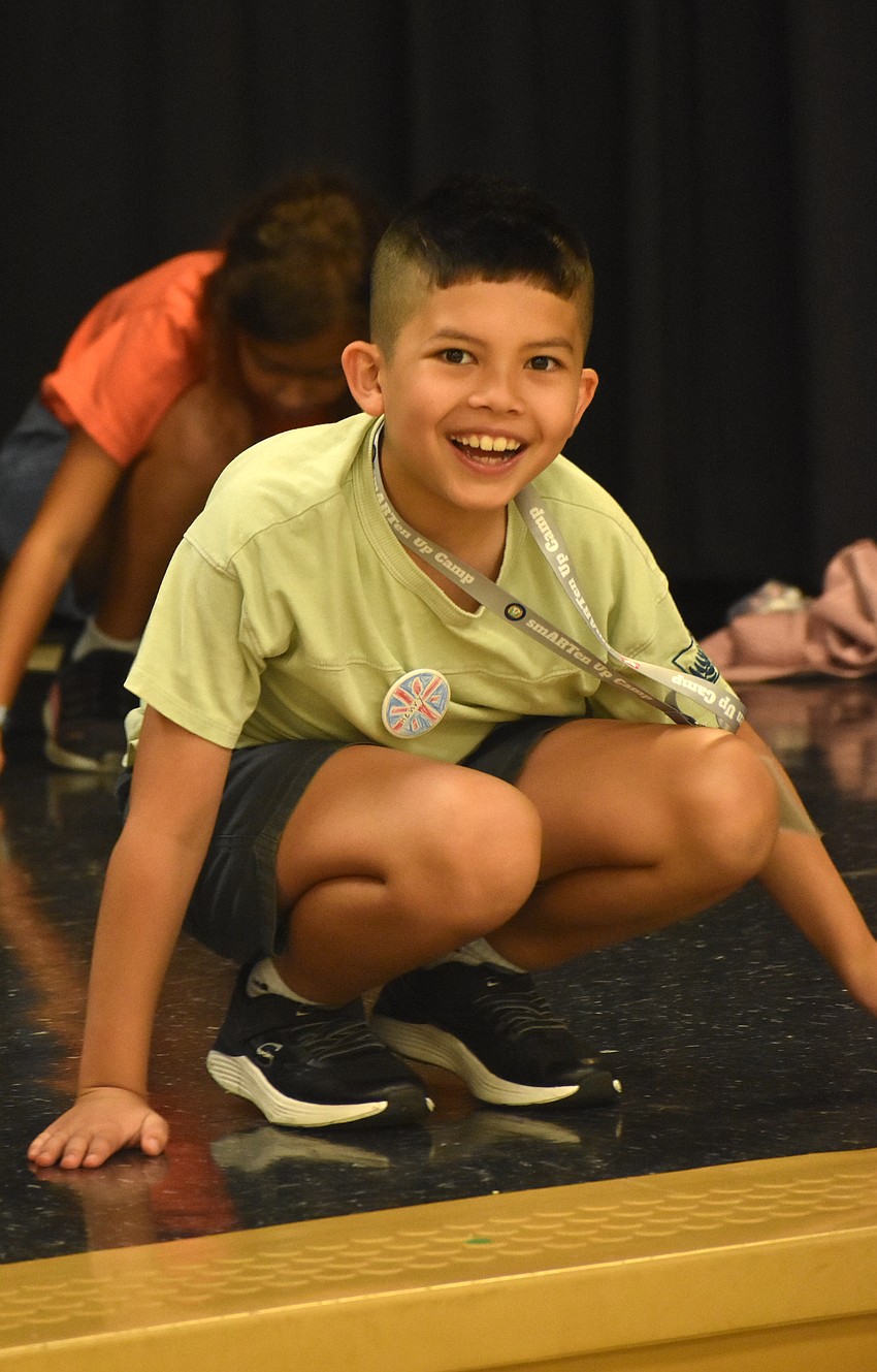 Henry Michaels, a rising fourth grader at Freedom Elementary School, follows choreography as Marisol Rosas, dance teacher from Rowlett Elementary Academy, gives direction.