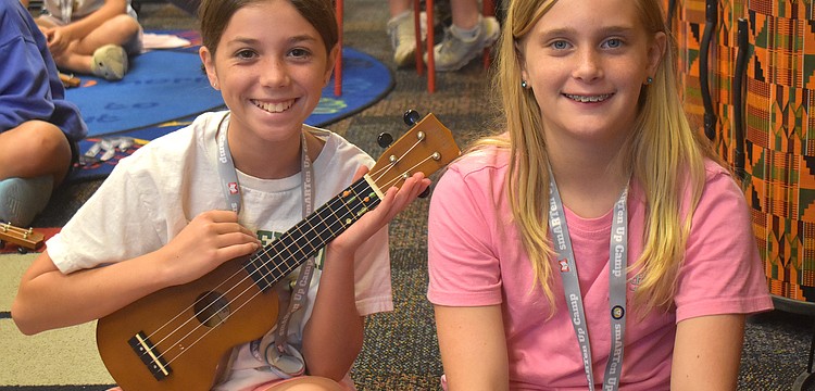 Isabella Cz, a rising sixth grader at Dr. Mona Jain Middle School, and Skylar Flandreau, a rising sixth grader at Martha B. King Middle School, take turns playing the ukulele during the Manatee Arts Education Council smARTen Up Camp.