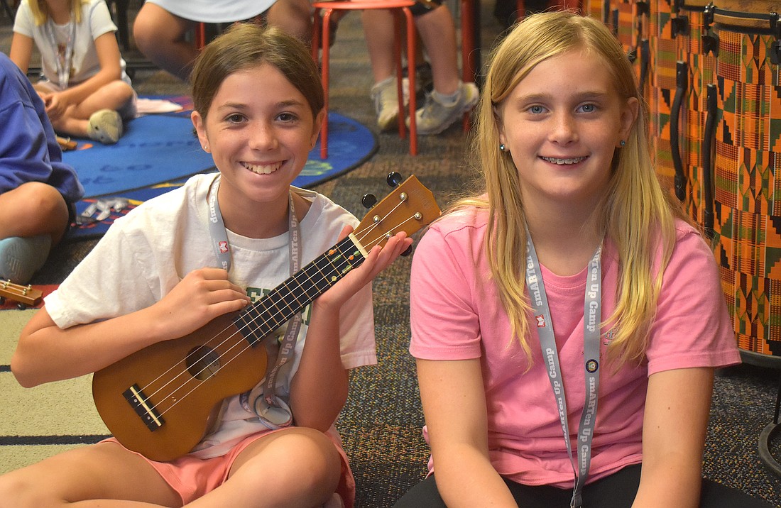 Isabella Cz, a rising sixth grader at Dr. Mona Jain Middle School, and Skylar Flandreau, a rising sixth grader at Martha B. King Middle School, take turns playing the ukulele during the Manatee Arts Education Council smARTen Up Camp.