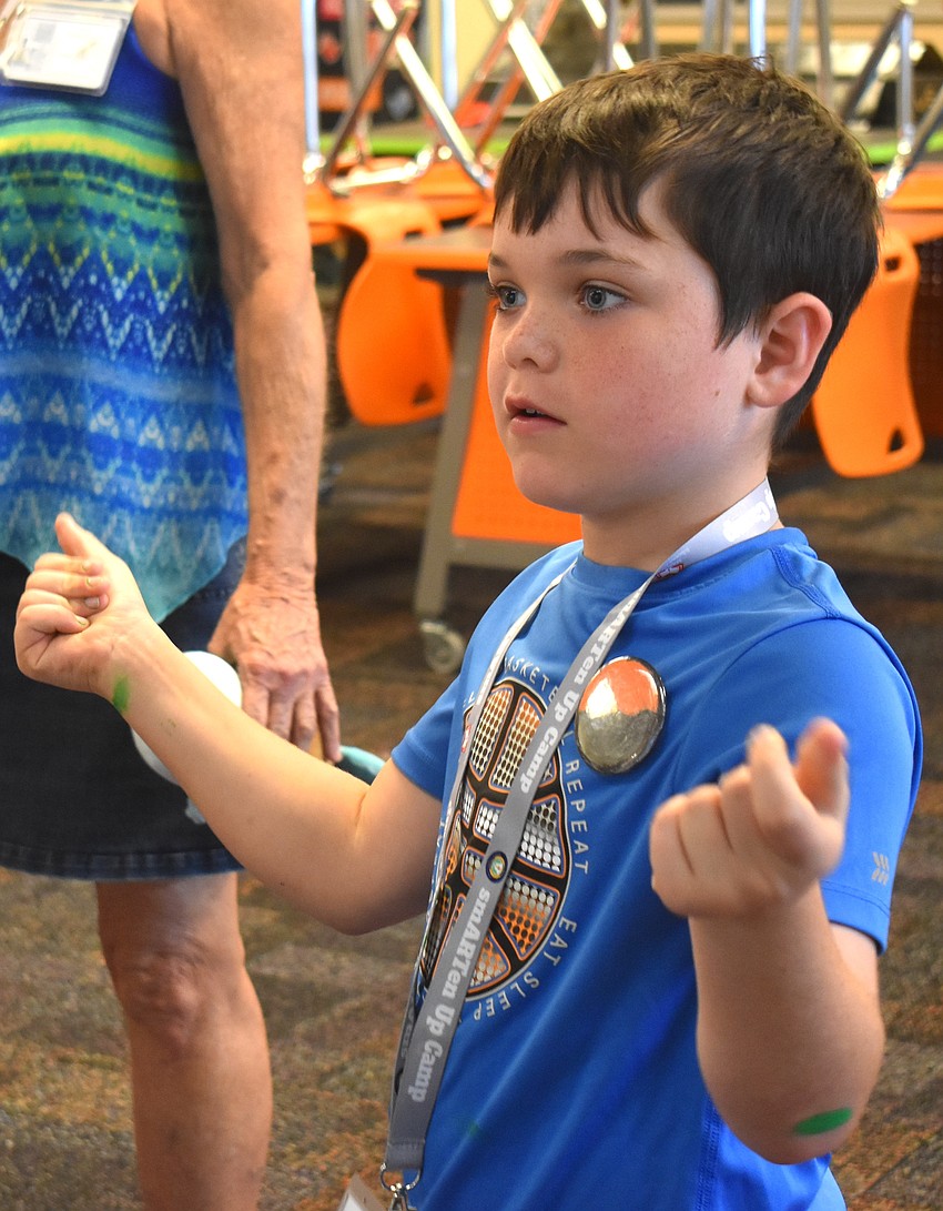 Liam Kane, a rising third grader at Braden River Elementary, dances along to 