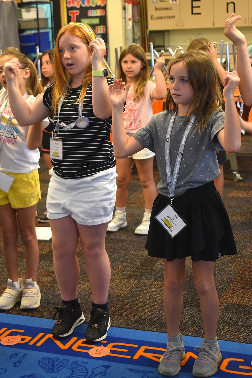 Rising third graders Tessa Barcelona of Willis Elementary and Isla Cz of Braden River Elementary dance along to 