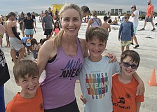 Brody Floyd, 6, his mom Sara Floyd, and brothers Jacob Floyd, 9, and Benjamin Floyd, 6, prepare for the run.